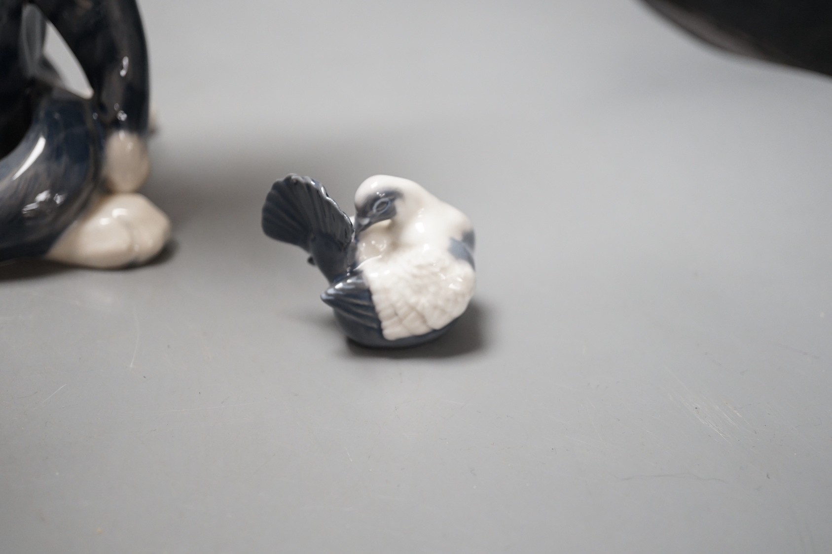A Royal Copenhagen cat 304, love birds 649, dove 4727, a Lladro dog's head and a Nao figure of a yawning dog - tallest 19cm (5)
